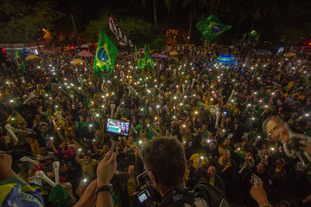 Dressed in green and yellow – the colors of the Brazilian flag – Brazilians celebrated the election of far-right candidate Jair Bolsonaro on October 28 in São Paulo. While his supporters hope he'll put the country back on track, his critics fear he'll turn back the clock on Brazilian democracy. (Photo by Léu Britto/DiCampana/GroundTRuth)