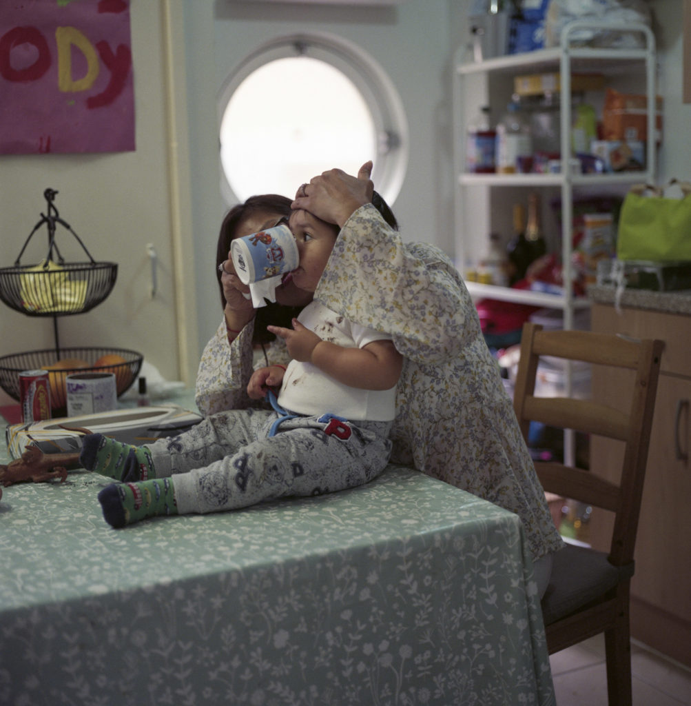 Tarek Gotti's wife and son Maddox in the kitchen of their home in Henry Dickens Court Estate.