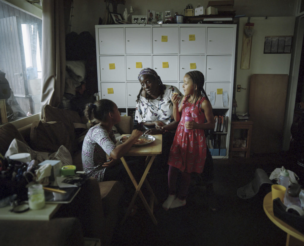 Noreen King sits with her two Grandchildren Franki (left) and Maicee (right) in Trellick Tower of North Kensington.