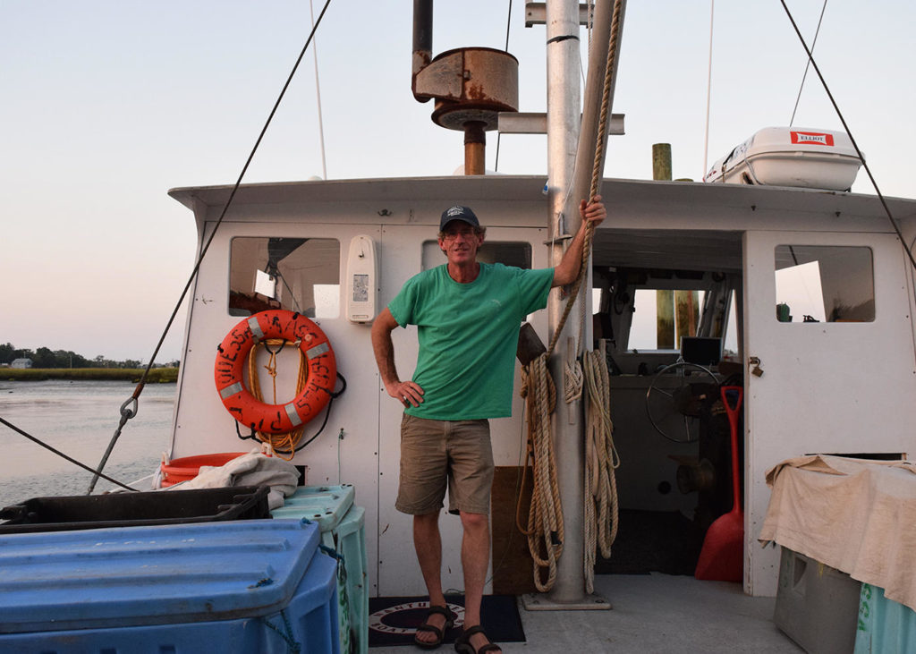 Tim Barrett of the fishing vessel Odessa works with scientists at UMass Dartmouth on technology that aims to improve fish counts. (Photo by Pien Huang/WCAI)