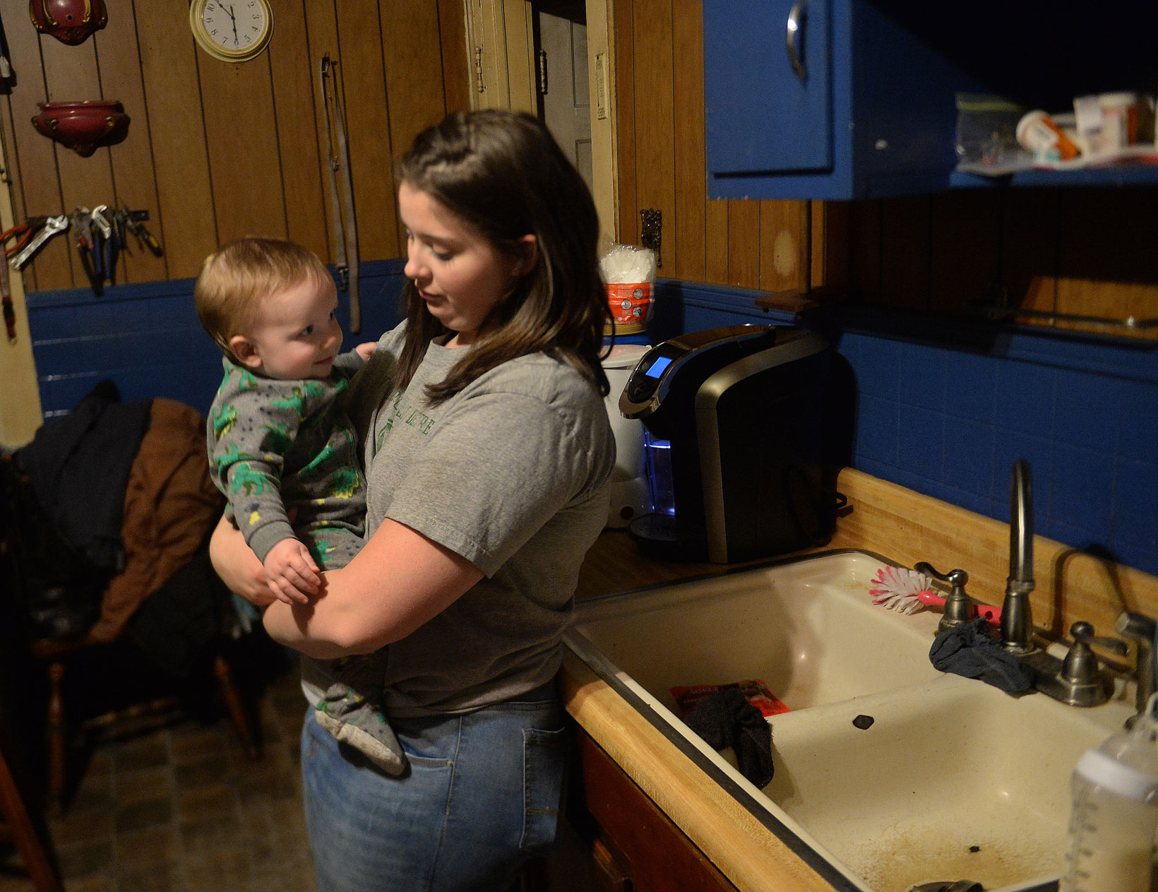 Cierra Coleman holds her 9-month-old son, Keaton, in her mother's Gary home. Cierra Coleman and her mother, Tina Coleman, are especially concerned with water quality now that Keaton is in the home. Each day, they avoid the water coming out of their bathtub, and instead use bottled water to bathe him. (Photo by F. Brian Ferguson | Gazette-Mail)