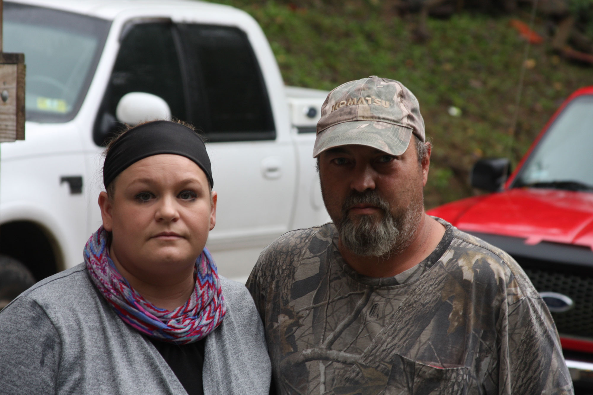 Jessica and Tim Taylor of Martin County collect water in buckets to deal with long water outages that have plagued their family. Photo by Will Wright / wwright@herald-leader.com