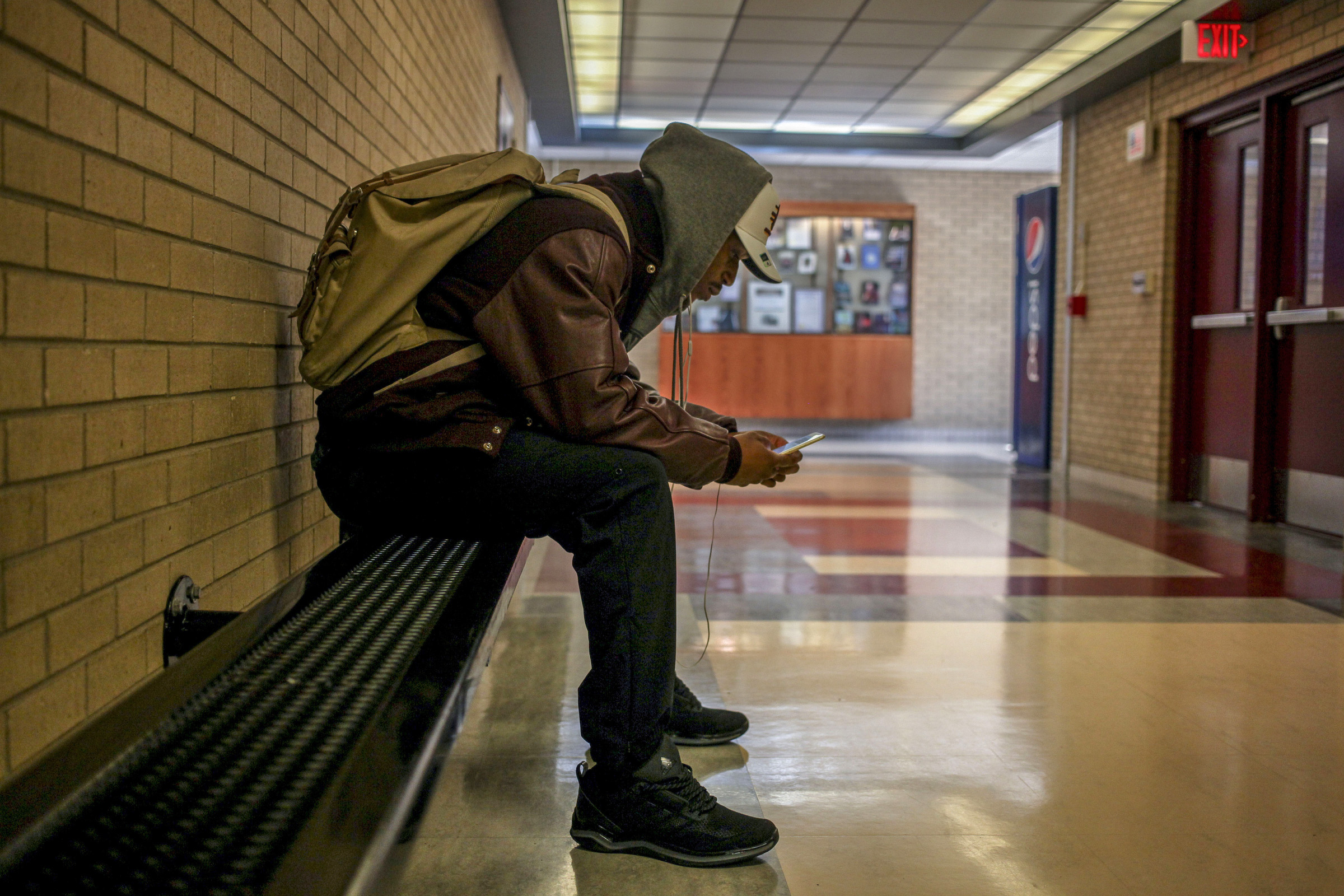 Ray Golden, Jr., scrolls through study notes before an exam in Anspach on the campus of Central Michigan University where he is studying political science and non profit law. Golden is the second generation in his family to attend college and the says he carries the weight of the history if the struggle of African-Americans in America. “The more education I have the heavier the burden becomes- the more aware of how far we are behind,” he says. “How are we supposed to get ahead if we’ve only been going to college for one generation?” (Photo: Josephine Norris/GroundTruth)