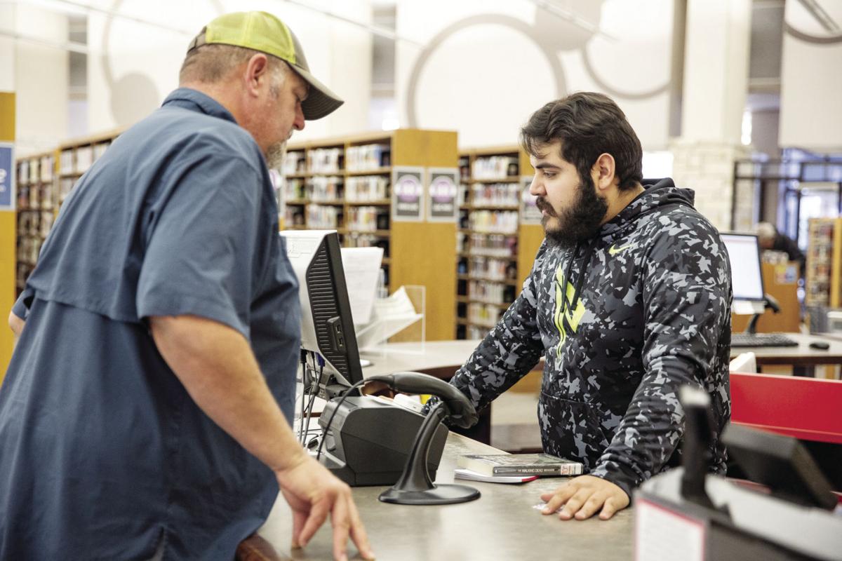 A patron at the front desk of the library.