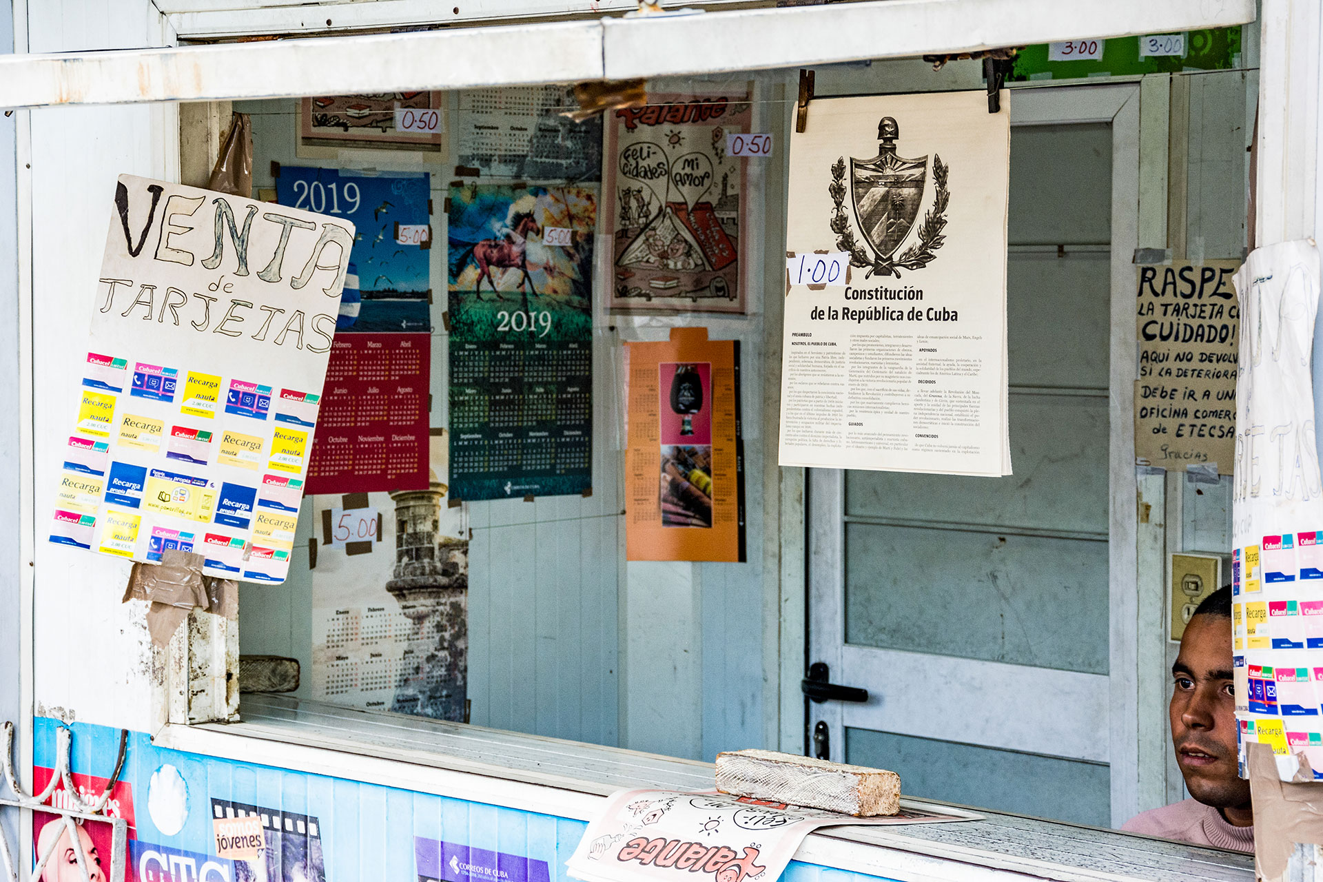 Copies of Cuba’s new constitution, which Cubans voted in favor of in February, are for sale at a street vendor March 6, 2019, in Havana, Cuba. The new constitution, Cuba’s first since 1976, recognizes private property, creates a term limit for the president and bans discrimination based on gender or sexuality, among other measures. (Photo by Story Hinckley/GroundTruth)